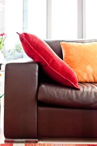 leather sofa and colorful cushions in London holiday apartment