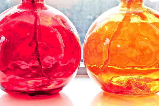 red and orange glass vases in London holiday flat