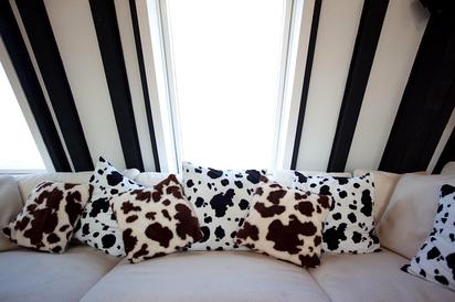 cow cushions on large sofa